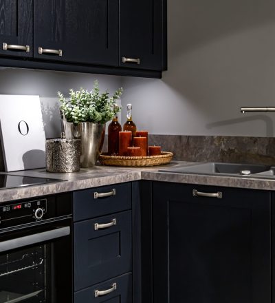 Dark kitchen cabinets with metal pulls or knobs in home interior.